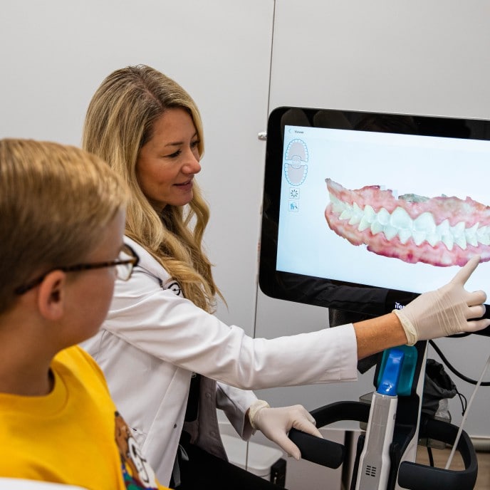 Dr. Otto showing patient his teeth